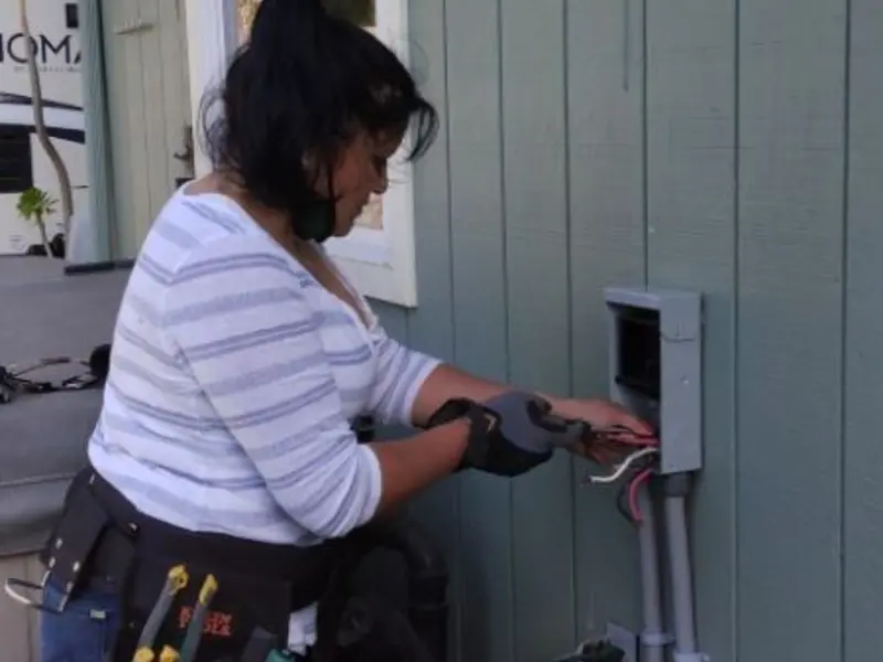 Licensed electrician wiring an exterior subpanel in Santa Barbara